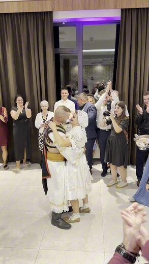 Newlyweds leaving the church under an arch of hockey sticks